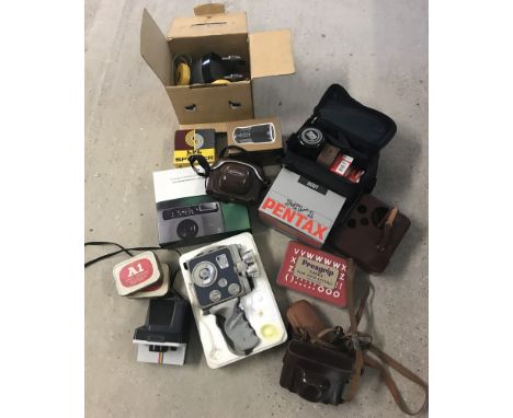 Vintage cameras and photographic equipment. To include a boxed Eumig C3m handheld 8mm cine camera together with a boxed Penta
