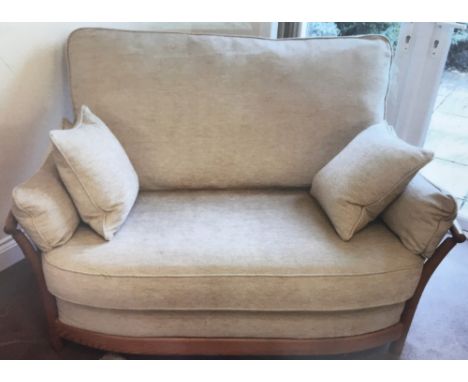 A modern Ercol 2 seater "Renaissance" settee with beige coloured upholstery and light elm wooden frame. 