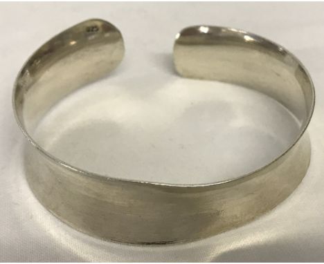 A ladies silver cuff bangle. Marked 925.  Total weight 26.1g.