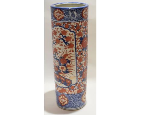 Japanese porcelain stick stand, Meiji period, decorated in Imari style with iron red foliage on a blue ground, 62cm high 