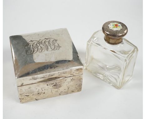An Edwardian silver mounted cigarette box, marks rubbed, 90mm, together with a white metal and enamel topped glass scent bott