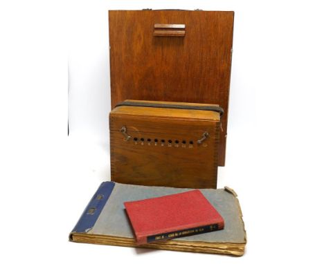 A collection of watch parts, tools and a small selection of costume jewellery, housed in two cases, together with two books. 
