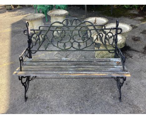 A Victorian style cast iron slatted garden bench, width 106cm, height 76cm. Condition - poor