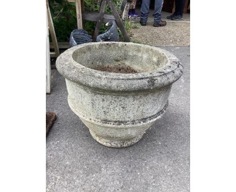 A circular reconstituted stone garden planter diameter 52cm, height 41cm. Condition - good