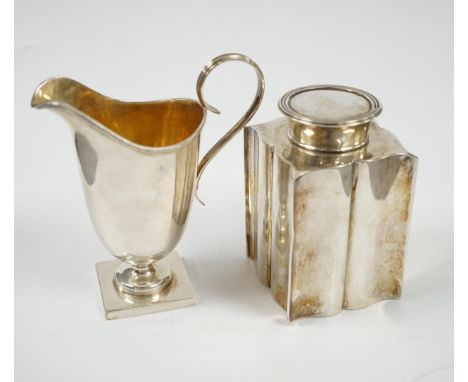 An Edwardian silver ‘bats wing’ tea caddy, Birmingham, 1906, 95mm and a George V silver cream jug. Condition - fair