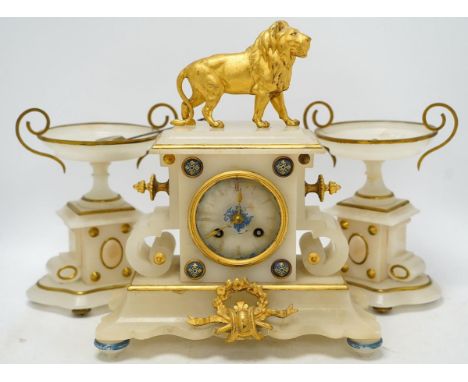 An early 20th century alabaster and gilt metal clock garniture with enamel panels, surmounted with a lion, with pendulum, no 