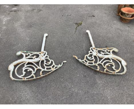 A pair of Victorian style cast iron rocking garden bench ends, height 99cm. Condition - fair