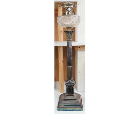 A silver plated oil lamp in the form of a Corinthian column with cut glass reservoir, 76cm high. Condition - fair to good, mi