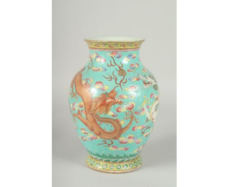 A 19TH CENTURY CHINESE TURQUOISE GROUND FAMILLE ROSE PORCELAIN DRAGON VASE, the body enamel painted with dragons and the flam