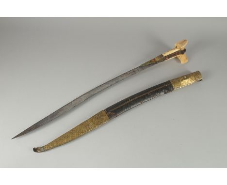 A FINE 19TH CENTURY OTTOMAN TURKISH YATAGHAN SWORD with coral inset walrus handle and silver inlaid blade in original scabbar