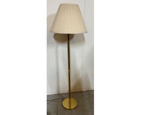 A brass standard lamp with fluted shade 