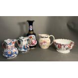 A selection of jugs, a bowl and a floral painted centre piece