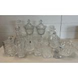 A selection of cut glass and crystal items to include brandy balloons, decanters and lidded vases