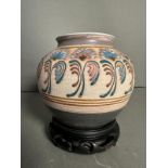An Arts and Crafts style stoneware vase with floral painted relief