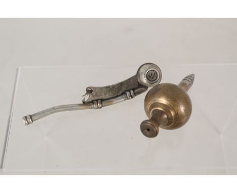 A brass plum bob marked 1936 A.M. with a broad arrow marked Bosons Whistle