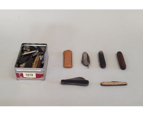 A tin of various pocket knives