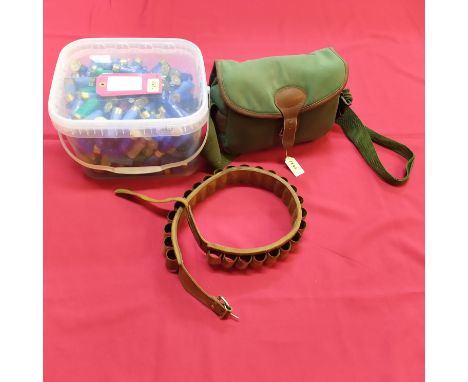 A tub of approx two hundred and thirty 12 bore cartridges with a leather cartridge belt and a cartridge bag, this item can on