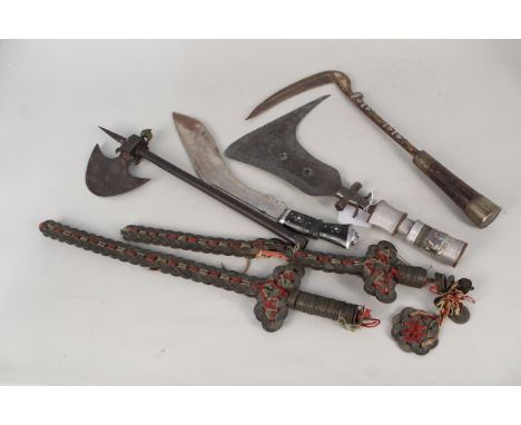 A collection of ethnic items including two Chinese coin 'cash swords' with a small axe etc