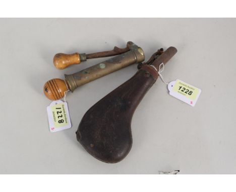 A twelve bore hand reloading tool with a leather shot flask (flask as found)