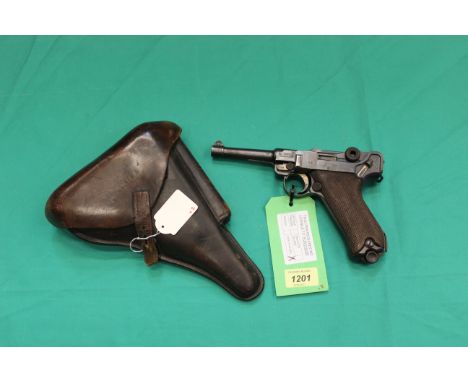 A 9mm Luger by D.W.M., dated 1916 with full matching serial numbers (3345), a very fine example with moving trigger and toggl