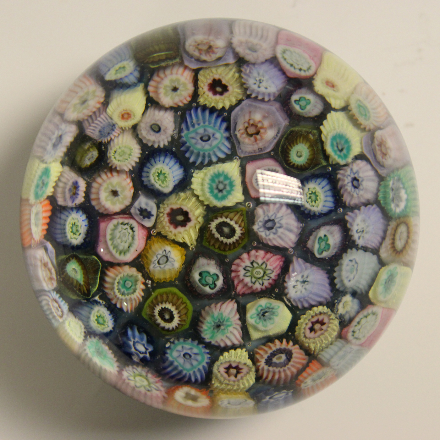 A Scottish Strathearn glass millefiori paperweight, set with a variety ...