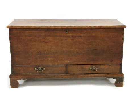 A George III oak blanket box, lifting lid, and two short drawers, on bracket feet, 123cm wide, 53cm deep, 69cm high