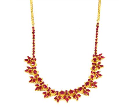 A high carat gold ruby fringe centrepiece necklace, with oval mixed cut rubies, possibly fracture filled , four claw set in l