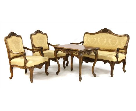 An Austrian walnut three piece salon suite, 20th century, consisting of a settee and two chairs, each with carved frame, and 