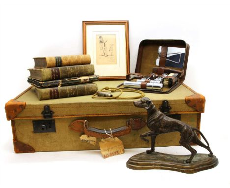 A vintage green cloth and leather bound travelling case, containing a cast model of a hound, together with a cartoon by Kenne