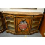 A GOOD VICTORIAN FIGURED WALNUT CREDENZA with central panelled mirrored door flanked by curving