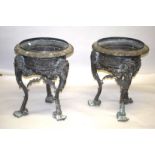 A LARGE PAIR OF BRONZE CIRCULAR PLANTERS on three curving legs with masks. 2ft 4ins high x 1ft 10ins
