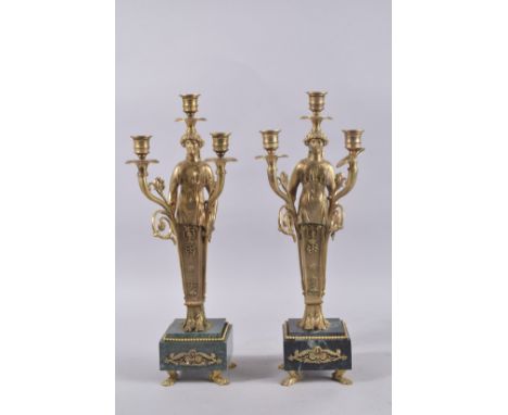 A GOOD PAIR OF EMPIRE DESIGN METAL THREE-LIGHT CANDELABRA on square marble base. 18ins high.