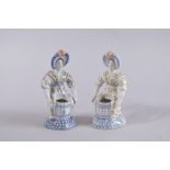 A GOOD PAIR OF POLYCHROME FIGURE SALTS. 7ins high.