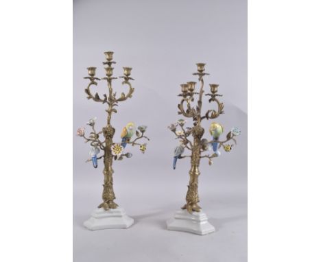 A GOOD PAIR OF GILT METAL AND PORCELAIN BIRD FOUR-BRANCH CANDELABRA. 23ins high.