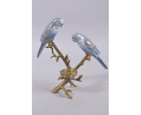 A BLUE BUDGIE AND METAL CANDLESTICK. 10ins high.