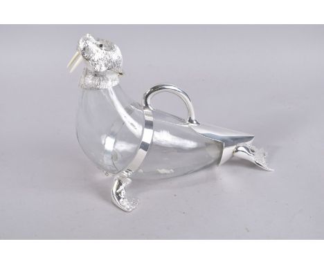 A LARGE PLAIN GLASS NOVELTY DECANTER with walrus head. 15ins high.