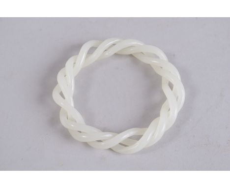 AN ARTICULATED WHITE JADE BANGLE. 3.25ins diameter.