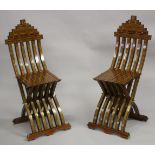 A PAIR OF MOROCCAN MARQUETRY INLAID WOODEN FOLDING CHAIRS.