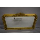 A LOUIS XVI STYLE GILTWOOD OVERMANTLE MIRROR. 4ft 4ins wide x 2ft 8ins high.