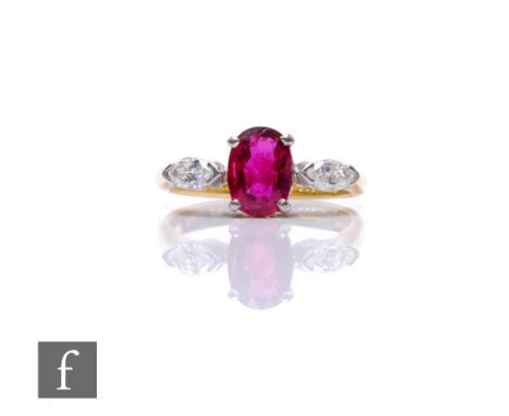 An 18ct hallmarked ruby and diamond three stone ring, central oval ruby, length 7mm, flanked by a marquise cut diamond to eac