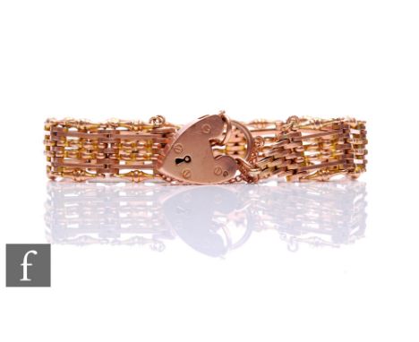 A 9ct rose gold six bar fancy link gate bracelet weight 24g, terminating in padlock fastener. 