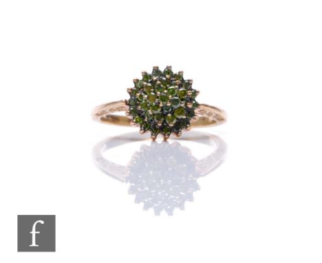 A 9ct hallmarked green diamond cluster ring, three tier stepped cluster to knife edged shoulders, weight 3.2g, ring size R. 