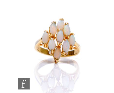 An 18ct opal cluster ring comprising nine marquise claw set stones, weight 3.5g, ring size M. 