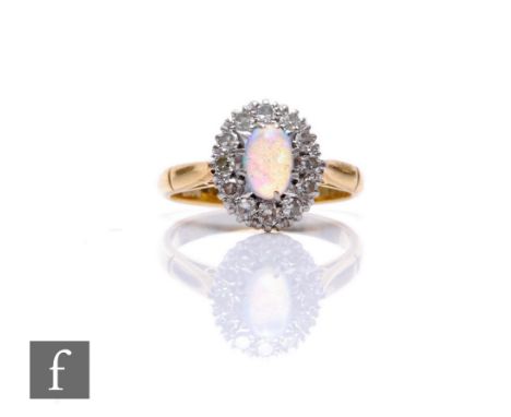 An 18ct opal and diamond cluster ring, central oval opal, length 6mm, within a border of twelve diamonds, weight 3.4g, ring s