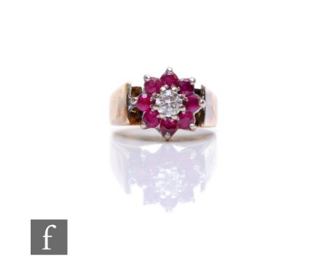 An 18ct hallmarked ruby and diamond cluster ring, central diamond within an eight stone border, weight 3.2g, ring size B. 