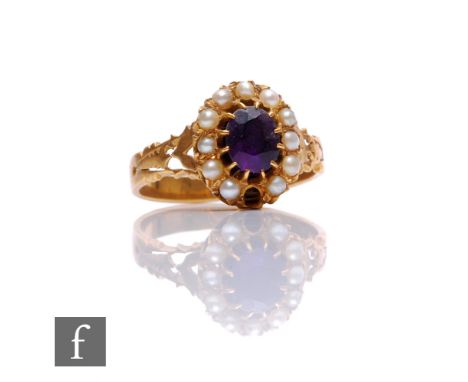 An unmarked amethyst and seed pearl memorial ring, central amethyst within a border of twelve seed pearls, one missing, and a