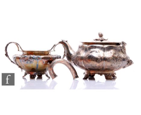 A hallmarked silver melon shaped teapot with part embossed foliate decoration raised on four scroll feet, with a matched suga