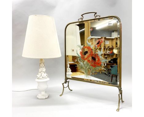 A Victorian brass fire screen and a ceramic lamp base.