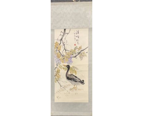 A 1960's Chinese watercolour scroll painting of a duck with blossom mounted with silk border, scroll size 54 x 146cm.