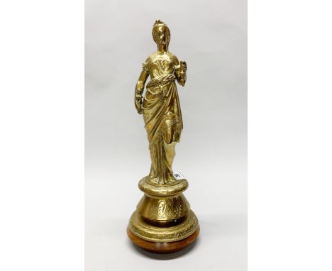 A 19th century brass figure of a woman in classical dress, previously a lamp base, with later turned teak base, H. 44cm.